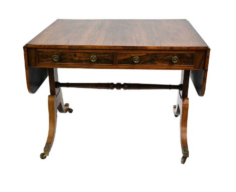 A Regency rosewood sofa table, circa 1820, curved end flaps, twin frieze drawers with circular brass pulls, baluster turned s