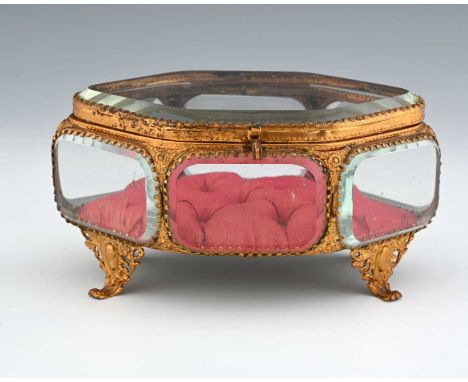 A French Palais Royal gilt metal and glass panelled jewel casket, mid 19th century, navette form with bevelled glass, button 
