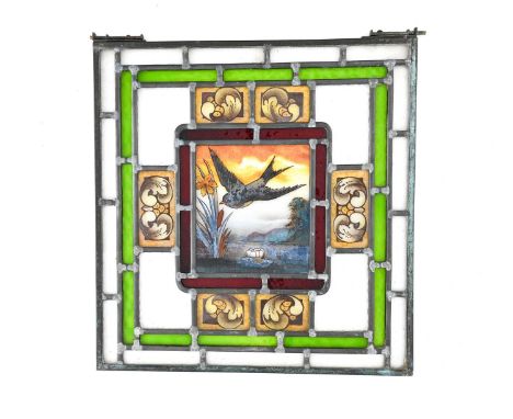 A matched pair of Aesthetic Movement stained glass leaded window panels, the central light painted with a swallow in flight o