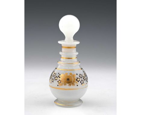 A French gilded opaline glass liqueur decanter, after Jean Baptiste Desvignes, circa 1810, footed ovoid mallet form with thre