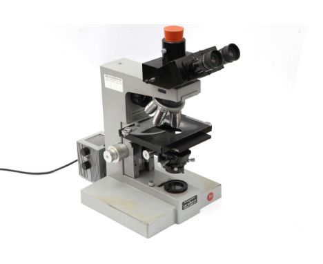 A Leitz Ortholux II Microscope, Circa 1970, serial No.837502, the grey painted body with black trinocular head, mechanical st