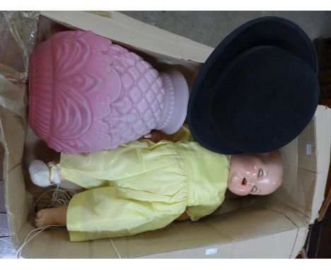 A pink glass light shade, a bowler hat and a doll 