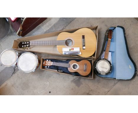 A Hofner guitar, a ukulele, pair of bongo drums, a banjo and a Haro harmonica 