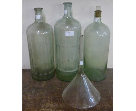 Three vintage glass poison bottles and a funnel 