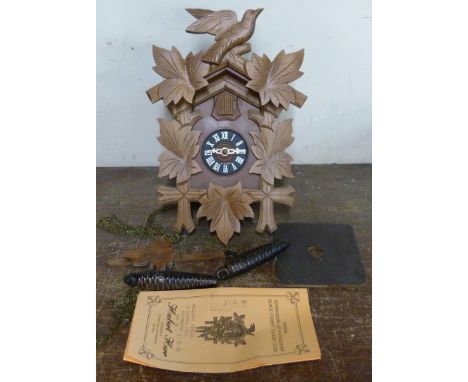 A Black Forest beech and faux wood cuckoo clock 