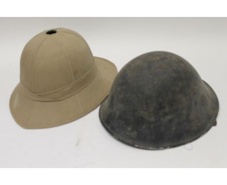 Second World War Italian steel helmet with elasticated chin strap, together with a pith helmet with leather head ring (2) 