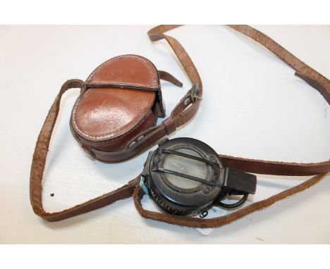 Second World War British prismatic marching compass,  no. 3034A on reverse, in original brown leather outer case.  Provenance