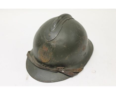 Second World War Polish military helmet with applied metal badge, brown chin strap and lining