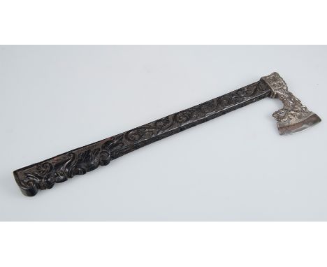 Silvato axe in carved ebony wood, silver and iron. Italy. 19th century.The handle in carved wood with vegetal motifs topped b
