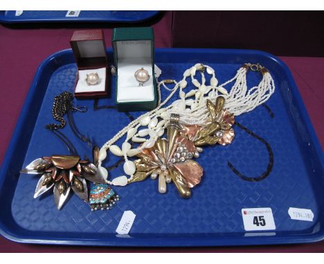 A Delicate Double Sided Enamel Pendant, with inset highlights, and suspending bead detail, on imitation pearl necklace, a mul