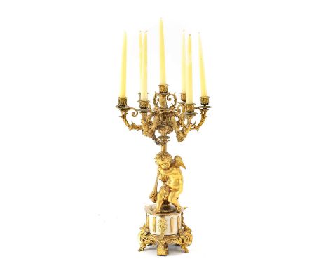 A French Gilt Metal Seven-Light Figural Candelabrum, 19th century, with leaf-sheathed sconces and scroll branches on a leaf-s