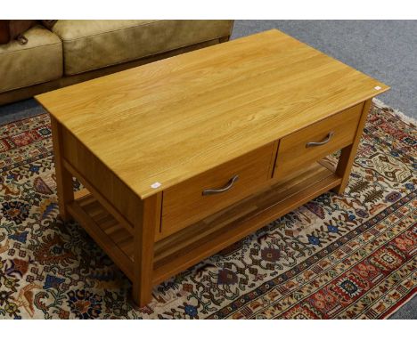 A modern light oak two drawer coffee table, 110cm by 58cm by 50cm