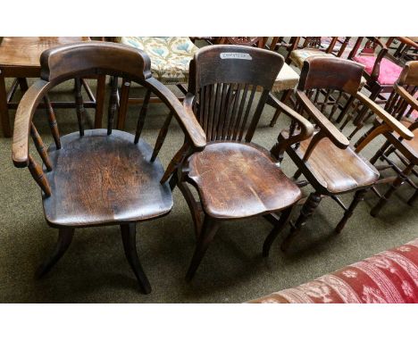 An early 20th century smokers bow armchair; together with an oak stick back armchair and a spindle back swivel office chair, 