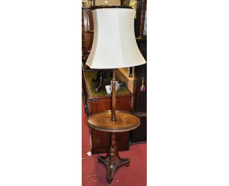 A reproduction mahogany and pierced brass galleried standard lamp, with oval central platform, h.125cm (excluding fittings)