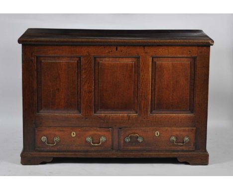 An 18th century joined oak three panel mule chest, the three plank hinged cover opening to reveal candlebox fitted interior, 