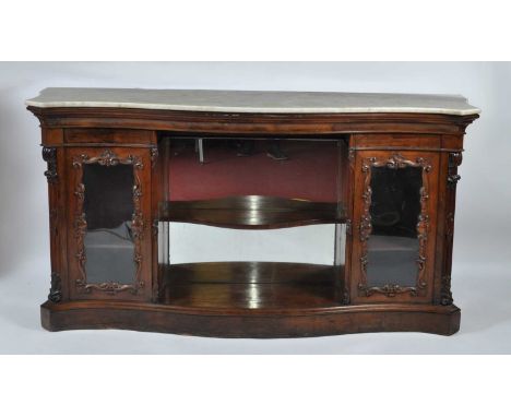 A Victorian rosewood marble-topped side cabinet, of serpentine outline, having twin glazed cabinets and a centre bowed shelf 