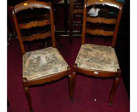 A set of four late 19th century French provincial fruitwood ladder back dining chairs