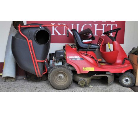 A Honda H1011 petrol-driven ride-on lawnmower, with grass collecting box, owner's manual, and two keys