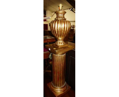 A contemporary gilt decorated ceramic fluted pedestal lampstand, with matching bulbous form lamp (2)