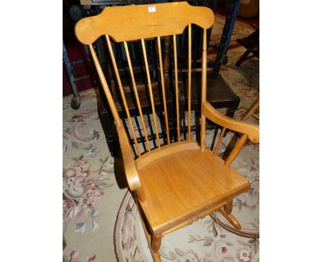 A contemporary beech stick back rocking armchair, width 59cm