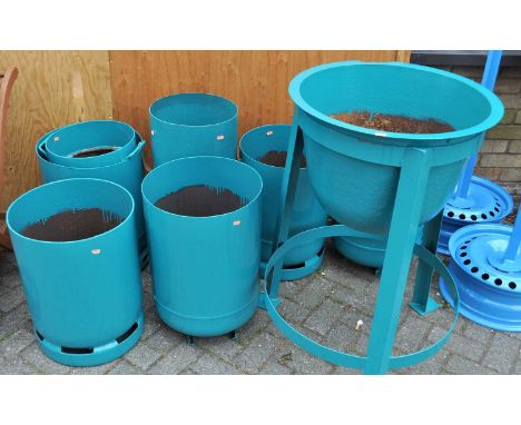 A collection of seven various painted steel re-worked garden planters, fashioned from gas canisters, together with a further 