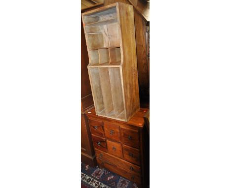 A contemporary Eastern hardwood low chest, fitted with eight various drawers, w.63.5cm; together with a plywood wall-mounted 