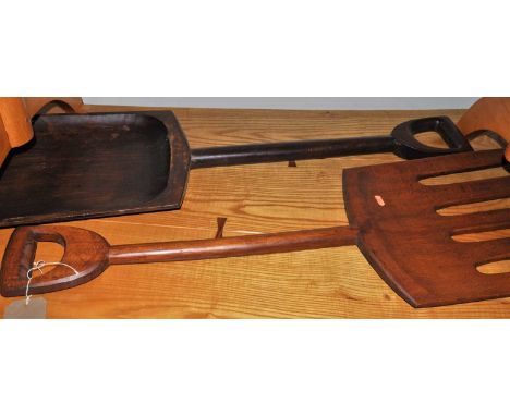 A novelty oversized stained beech pitch fork, with near matching shovel, each length approx 102cm