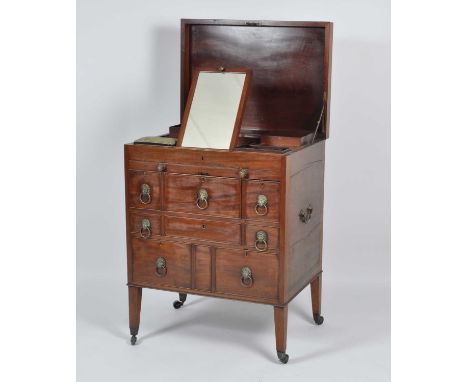 A late Georgian mahogany gentleman's fitted washstand, the hinged top opening to reveal well-fitted interior with hinged mirr