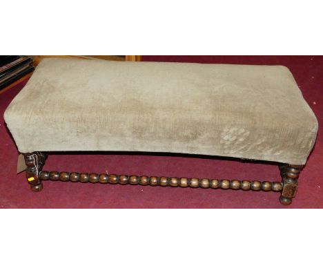 An early 20th century oak framed bobbin turned and upholstered twin foot stool, length 102cm