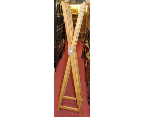 A contemporary light oak and chromed metal X-frame stand