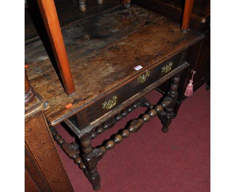 An antique joined oak plank topped single drawer side table, raised on bobbin turned and square cut supports, w.88cm 