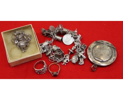 A silver charm bracelet, "Fozzie Bear" pendant on chain, a 9ct gold garnet set ring, a silver ring, and a silver locket
