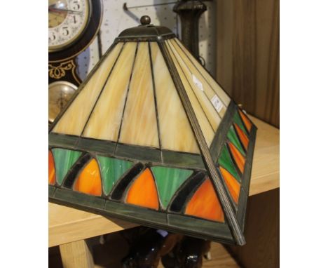 A table lamp with Tiffany style glass shade