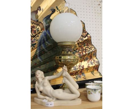 A brass oil lamp with opaque glass shade, together with the resin statue of a nude (2)