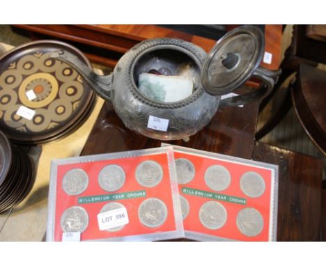 A selection of old coins, notes and Millennium crowns with a pewter teapot