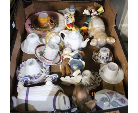 A box of a selection of porcelain and resin figures, Disney, cups and saucers etc