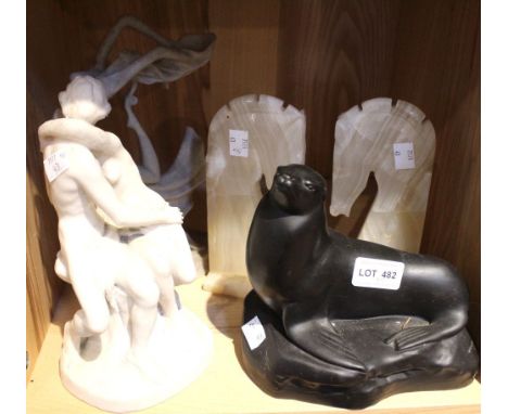 A shelf of collectible figurines including a sealion, a pair of onyx horse head bookends etc (5)