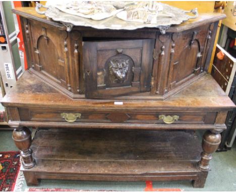 A 19th century oak buffet with cupboard top and draw under tier