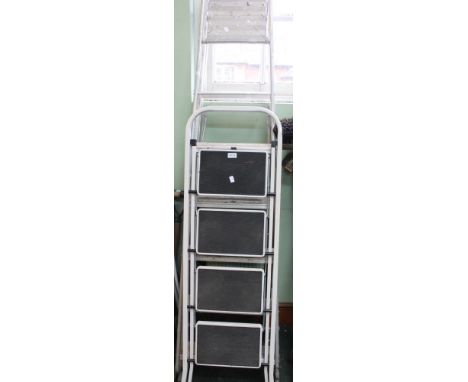 Two sets of folding step ladders and a sack truck