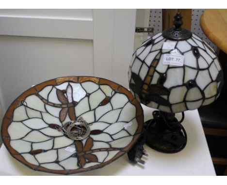 A table lamp with Tiffany style glass shade and a similar ceiling mounted shade
