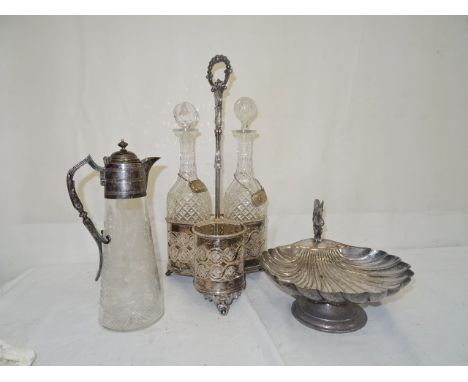 A Victorian silver plated nut dish; together with a Victorian claret jug and three decanter stands with two decanters
