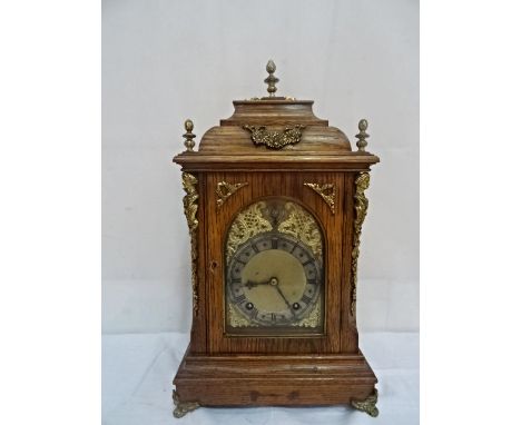 A 19th century oak brack clock with brass mounts & finial