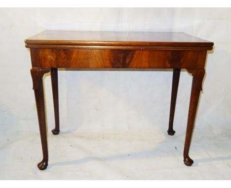 A mid-18th century mahogany concertina rectangular card table: The top with green baize-lined interior, on slender cabriole l