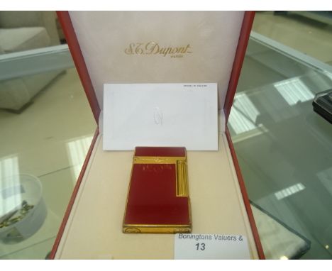 A cased Du Pont lighter