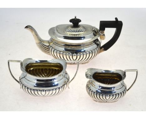 An Edwardian silver half-reeded three-piece bachelor tea service, William Devenport, Birmingham 1903, 18 oz gross
