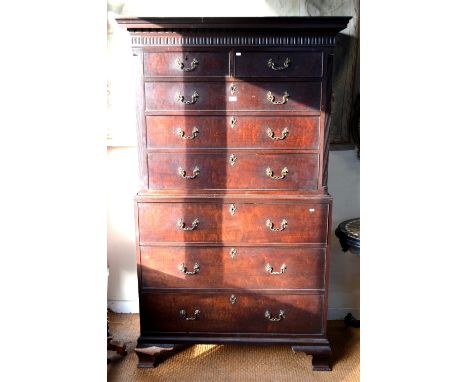 A George III mahogany chest on chest, having two short over three long graduated drawers over a fitted secretaire drawer and 