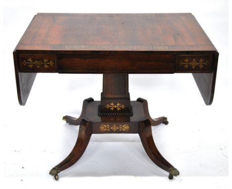 A Regency brass inlaid rosewood sofa table, the rounded drop end top over a frieze drawer flanked by brass inlaid tablets, ra