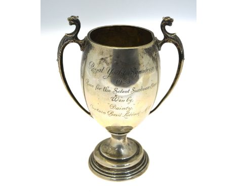 An ovoid silver trophy cup with twin handles surmounted by leopards' heads, with presentation inscription 'Royal Yacht Squadr