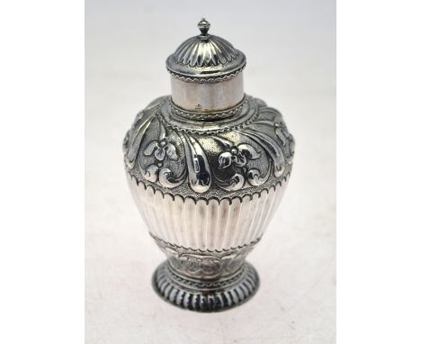 An 18th century Dutch ovoid tea caddy with embossed and chased floral decoration and half-reeding on flared foot rim, .875 gr