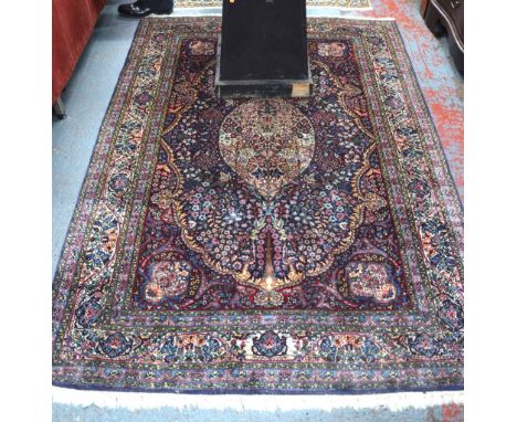 A Persian Kashan rug, the finely executed flowering garden design on red/blue ground, 2 m x 1.40 m